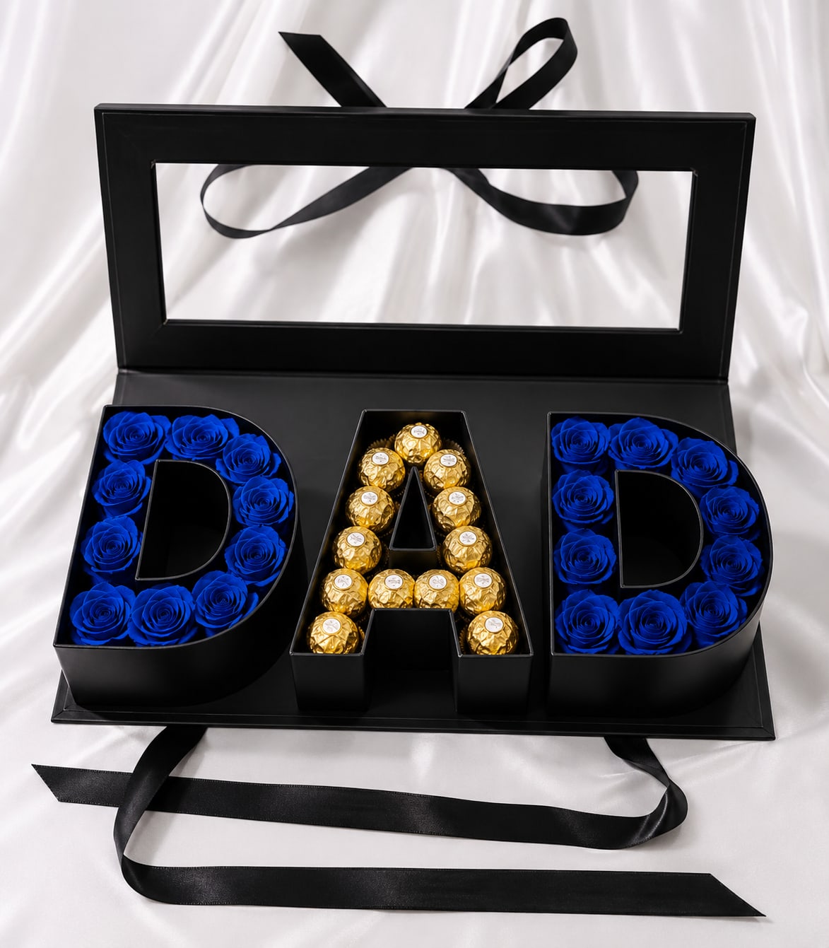 Luxury DAD Gift Box – Artificial Blue Roses &amp; Chocolates - Make Dad feel truly special with this elegant DAD gift box, thoughtfully designed with premium artificial blue roses that maintain their beauty over time and complemented by Ferrero Rocher chocolates for a touch of sweetness.  The sleek black presentation box makes this arrangement a memorable keepsake for Father’s Day, birthdays, or simply to show appreciation. The artificial roses require no maintenance and provide a lasting decorative piece that Dad can enjoy long after the celebration.  Important: This arrangement includes artificial flowers and is intended as a decorative keepsake. Chocolates are included as shown in the product images.