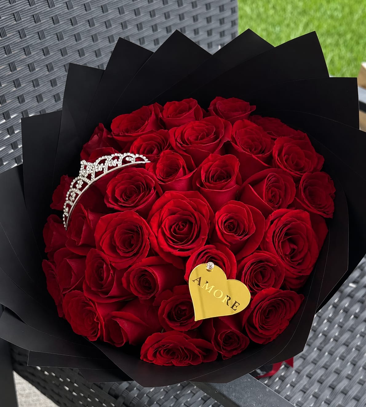 Luxury Red Roses Bouquet - Celebrate love with our elegant Luxury Red Roses Bouquet, handcrafted using premium fresh red roses and wrapped in sophisticated black designer paper for a timeless, luxurious look.  Whether you’re celebrating an anniversary, birthday, proposal, Valentine’s Day, or simply want to surprise someone special, this bouquet is designed to leave a lasting impression.  Choose the size that best fits your occasion while enjoying the same premium quality, elegant presentation, and exceptional freshness that AMORE Flowers is known for.  Features:  * Premium fresh red roses * Luxury black wrapping * Personalized message included * Handcrafted by AMORE Flowers * Local flower delivery in Nashville and surrounding areas * Same-day delivery available for eligible orders  Available Sizes  *  25 Roses *  50 Roses *  75 Roses  Every bouquet is carefully designed to ensure a beautiful presentation that expresses love, romance, and elegance.