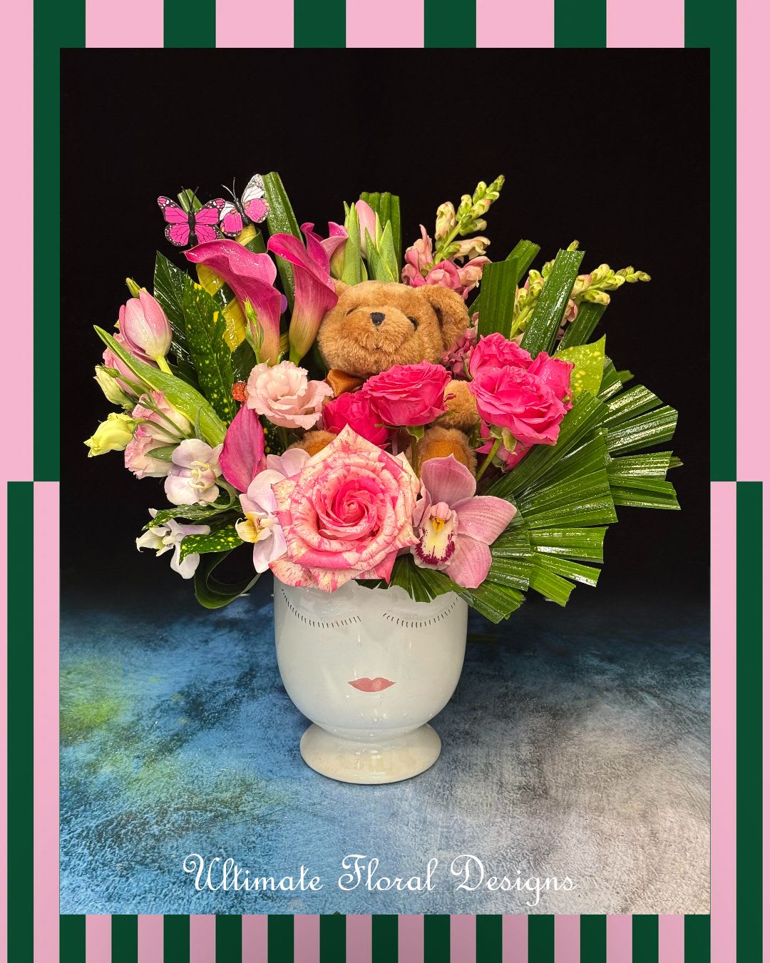 Pink floral arrangement with a teddy bear in a white vase