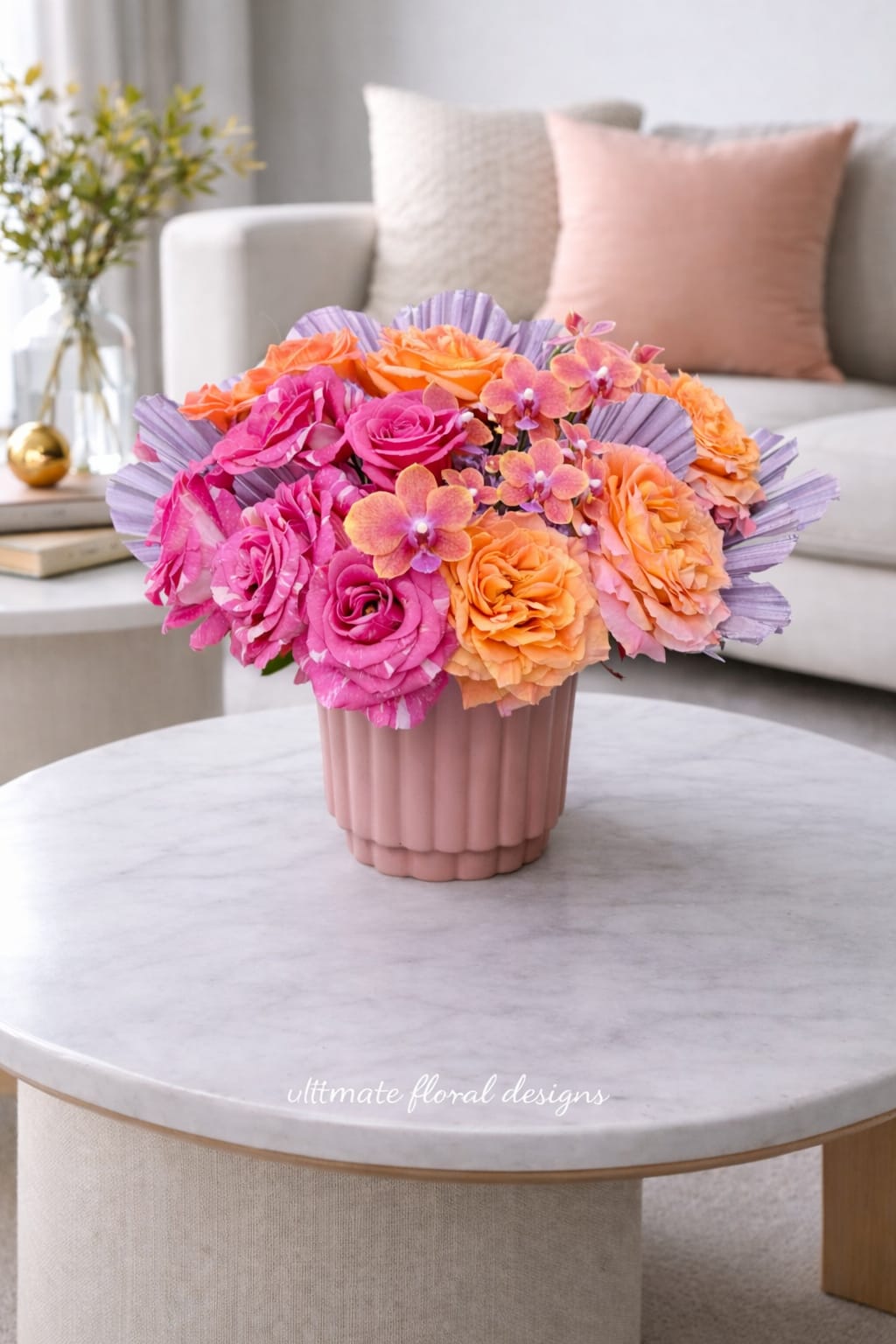 Sunset Orchid Garden - A vibrant and luxurious floral arrangement designed with premium garden roses in warm coral and vivid pink tones, accented by delicate mini orange-pink orchids for a refined, modern touch. Styled in a soft blush ceramic vase, this design brings warmth, elegance, and sophistication to any space.  Perfect for birthdays, celebrations, or simply elevating your home with fresh beauty, this arrangement reflects the signature artistry of Ultimate Floral Designs.  We proudly offer same-day flower delivery in Great Falls, McLean, Vienna, Reston, Arlington, and Washington, DC, ensuring your flowers arrive fresh and beautifully presented.