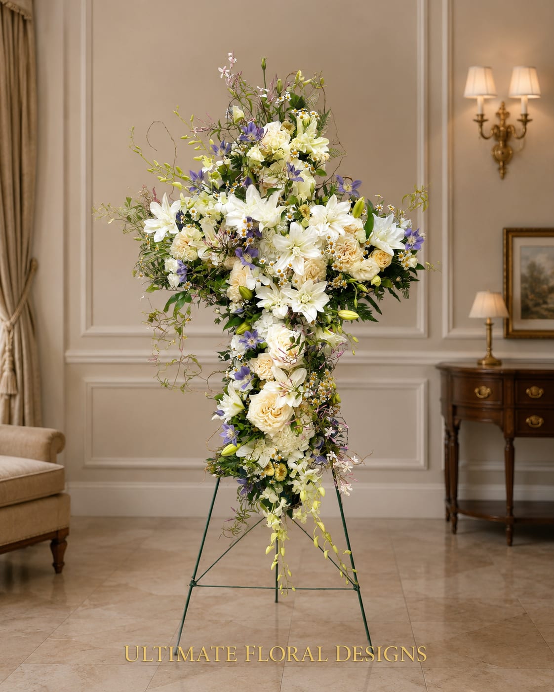 Tall standing floral cross with white and lavender flowers on a metal easel