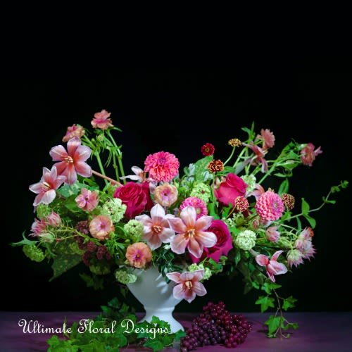 Mixed pink floral arrangement in a white vase