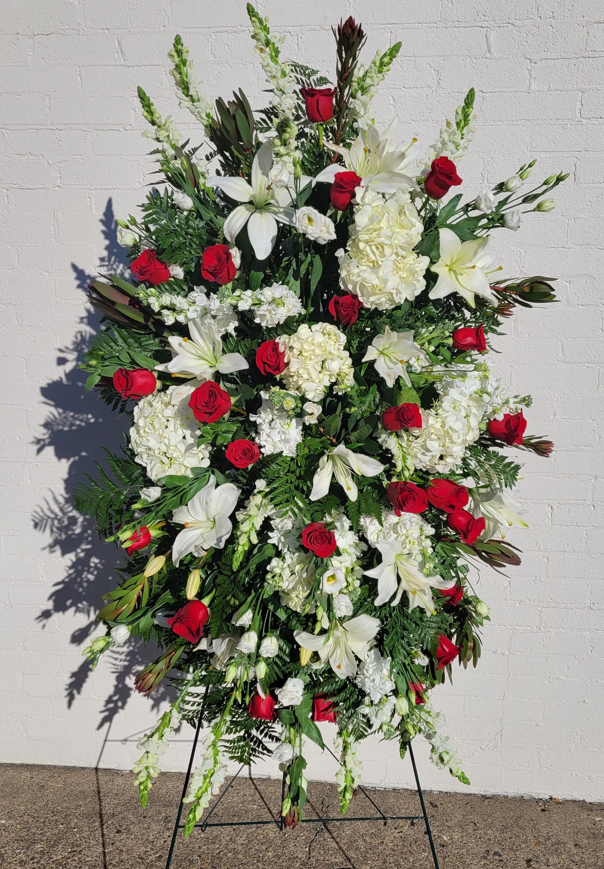 Red &amp; White Sympathy Standing Spray - Our Red and White Sympathy Spray is a simple yet beautiful tribute to honor a loved one. Red and white flowers accentuate the spray and are beautifully arranged. It will reflect the love and compassion you wish to express.