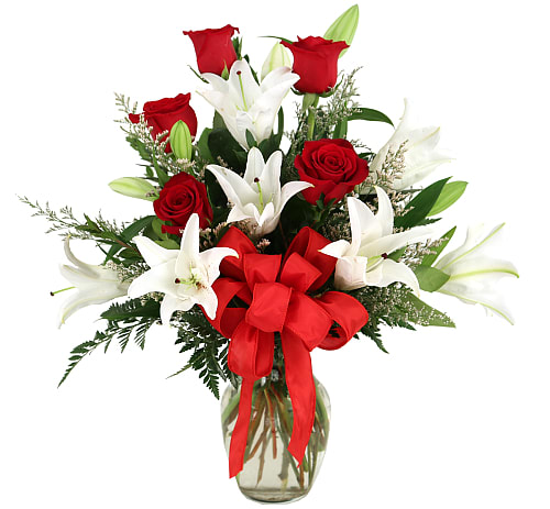 Lovelight Arrangement - Red for passion... white for love. Glass vase arrangement of love and passion! Featuring roses, lilies and limonium perfectly arranged and complemented by a delicate organza bow.