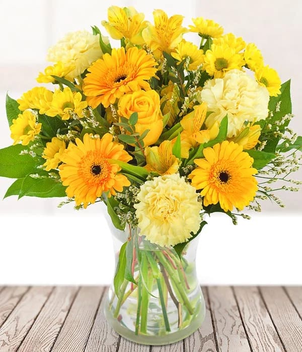 Golden Sunshine - This bright and bold bouquet is full of the most beautiful yellow stems, including a single yellow rose, long-lasting alstroemeria, germini, carnations and seasonal foliage. 