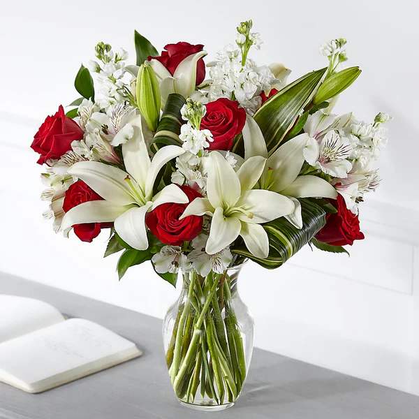 Loving Respect Bouquet - Elegantly crafted with a stunning mix of red and white blooms, our Loving Respect Bouquet reminds those you care about that you are thinking of them. Our talented designers arrange roses and lilies together to convey your comfort and love