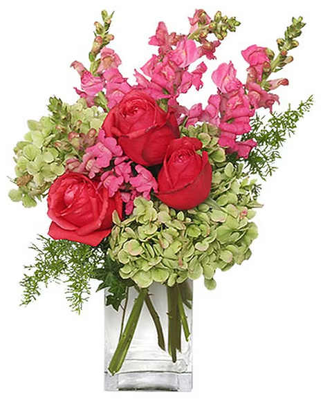 Pink and red flowers arranged in a clear glass vase