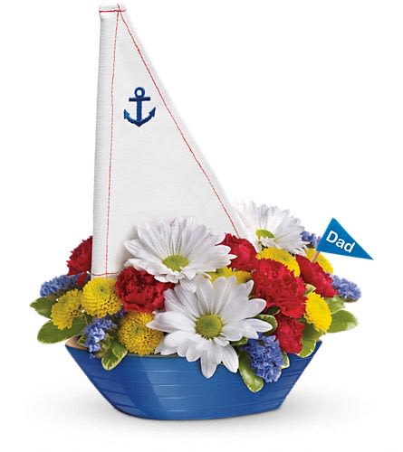 Daisy and carnation arrangement in a blue sailboat container with a Dad flag