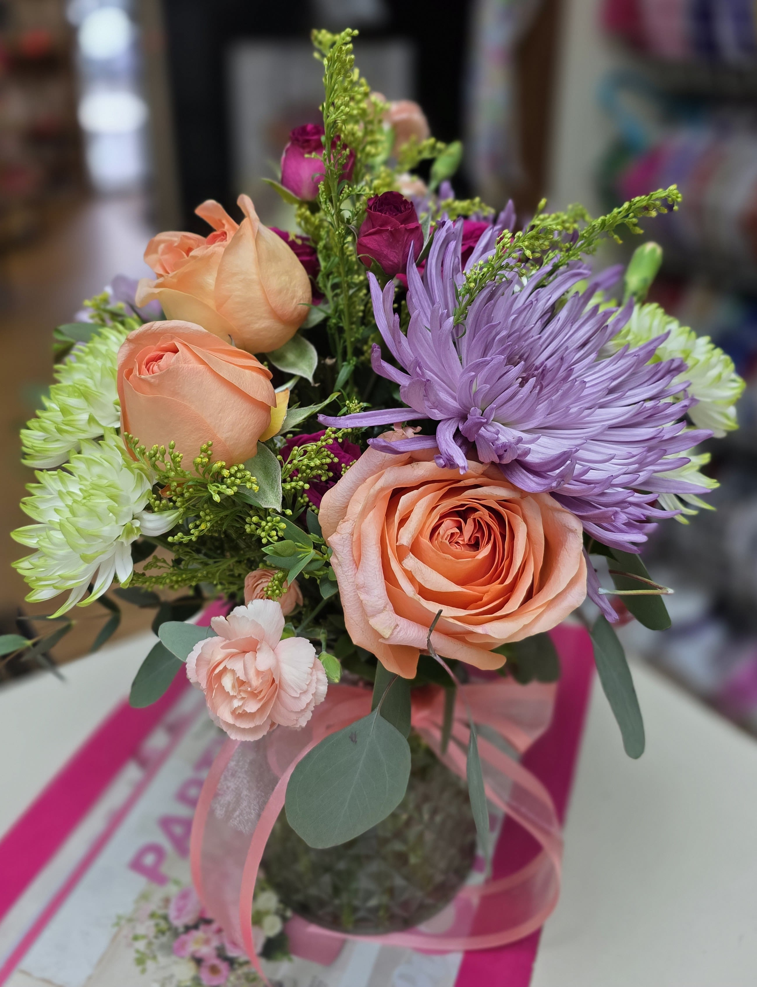 Magical Night Dreams - Magical Night Dreams bouquet transports you to twilight in the desert with colors of pale peach, hot pink, green, and purple sky for birthdays, anniversaries, or any celebration.   Flowers gathered in a soft color glass vase and topped off with a soft ribbon, the bouquet has a fresh, hand-tied feel of the twilight. Including roses, chrysanthemums, carnations, and accent blooms creates a beautiful way to remind your special person how grateful you are they are in your life. 