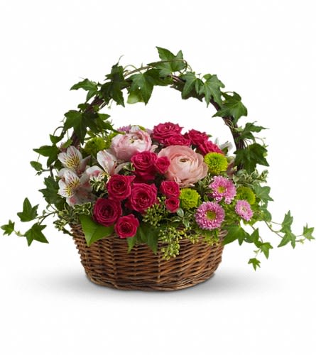 Basket of pink and red roses with mixed flowers and ivy