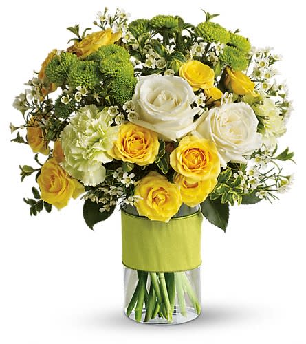 Yellow and white roses with green chrysanthemums in a glass vase
