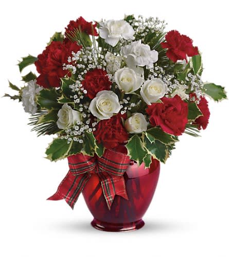 Red and white rose bouquet in a red glass vase with plaid ribbon