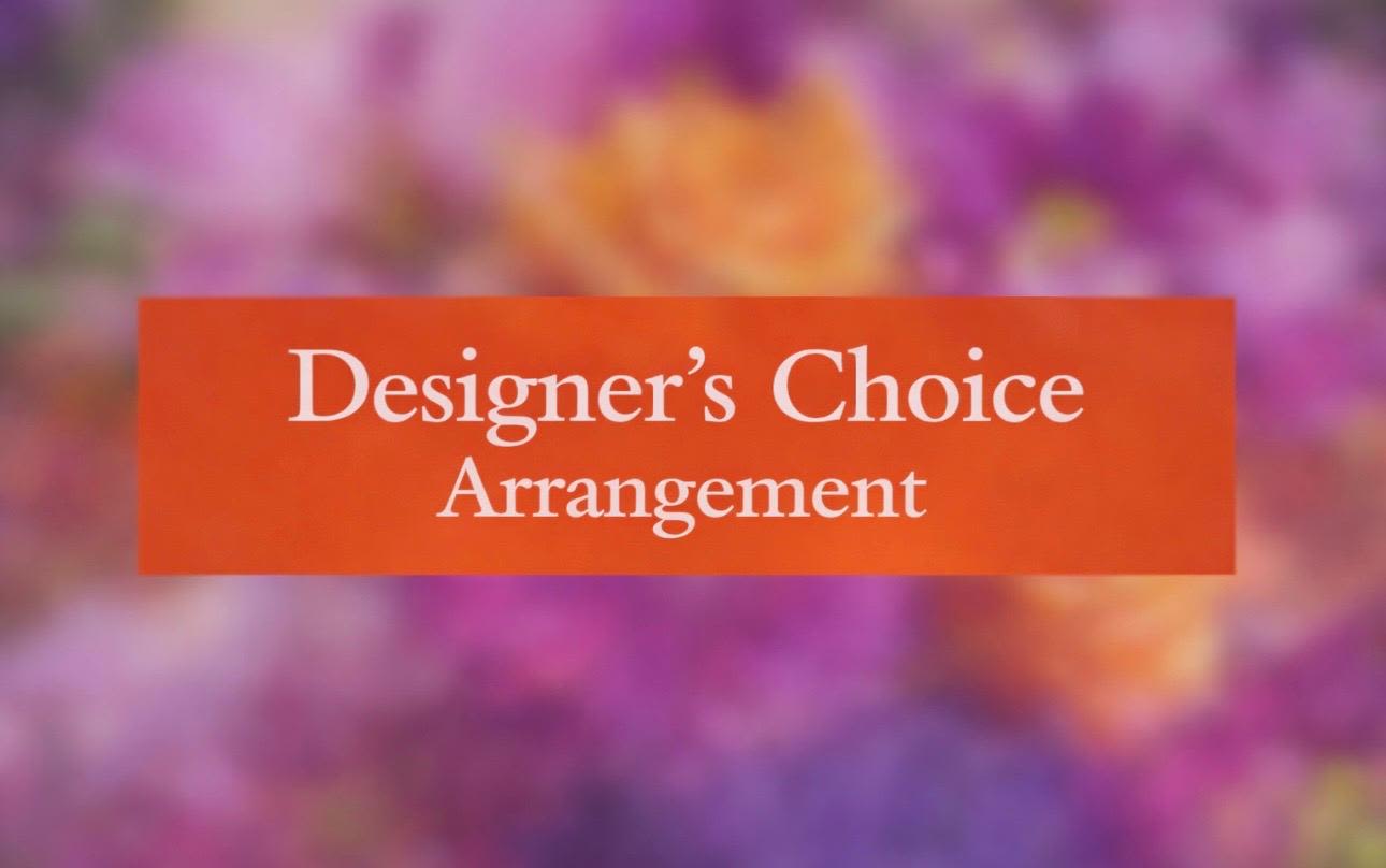 Designer’s Choice Arrangement sign over a blurred floral background