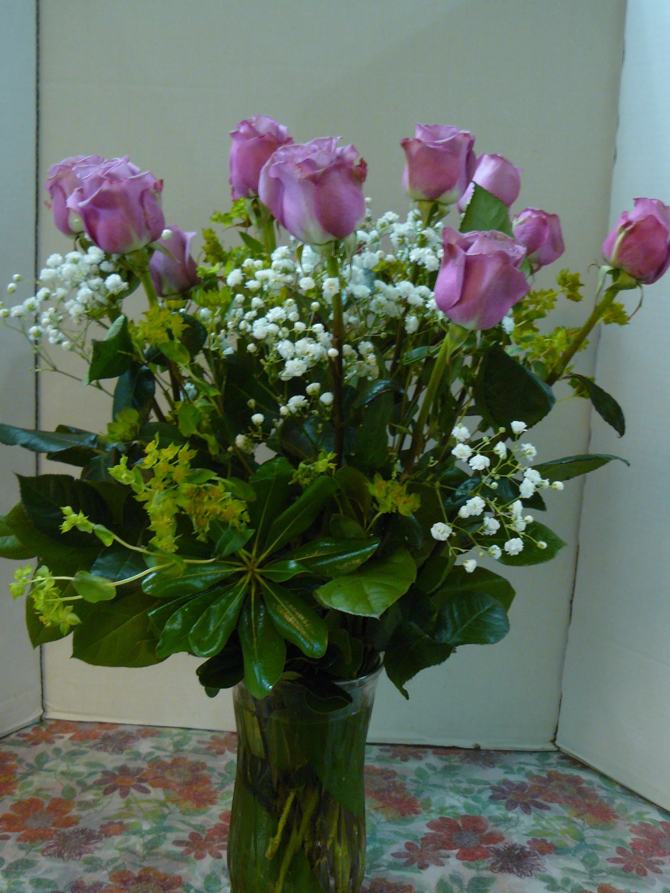 Pink roses with baby's breath in a glass vase