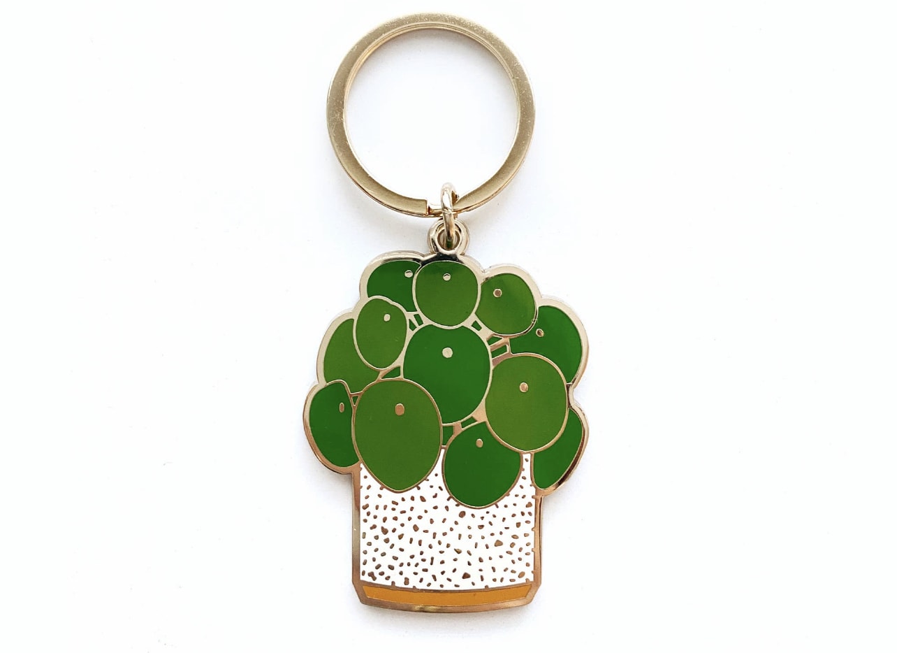 Potted plant keychain with green leaves and a gold ring