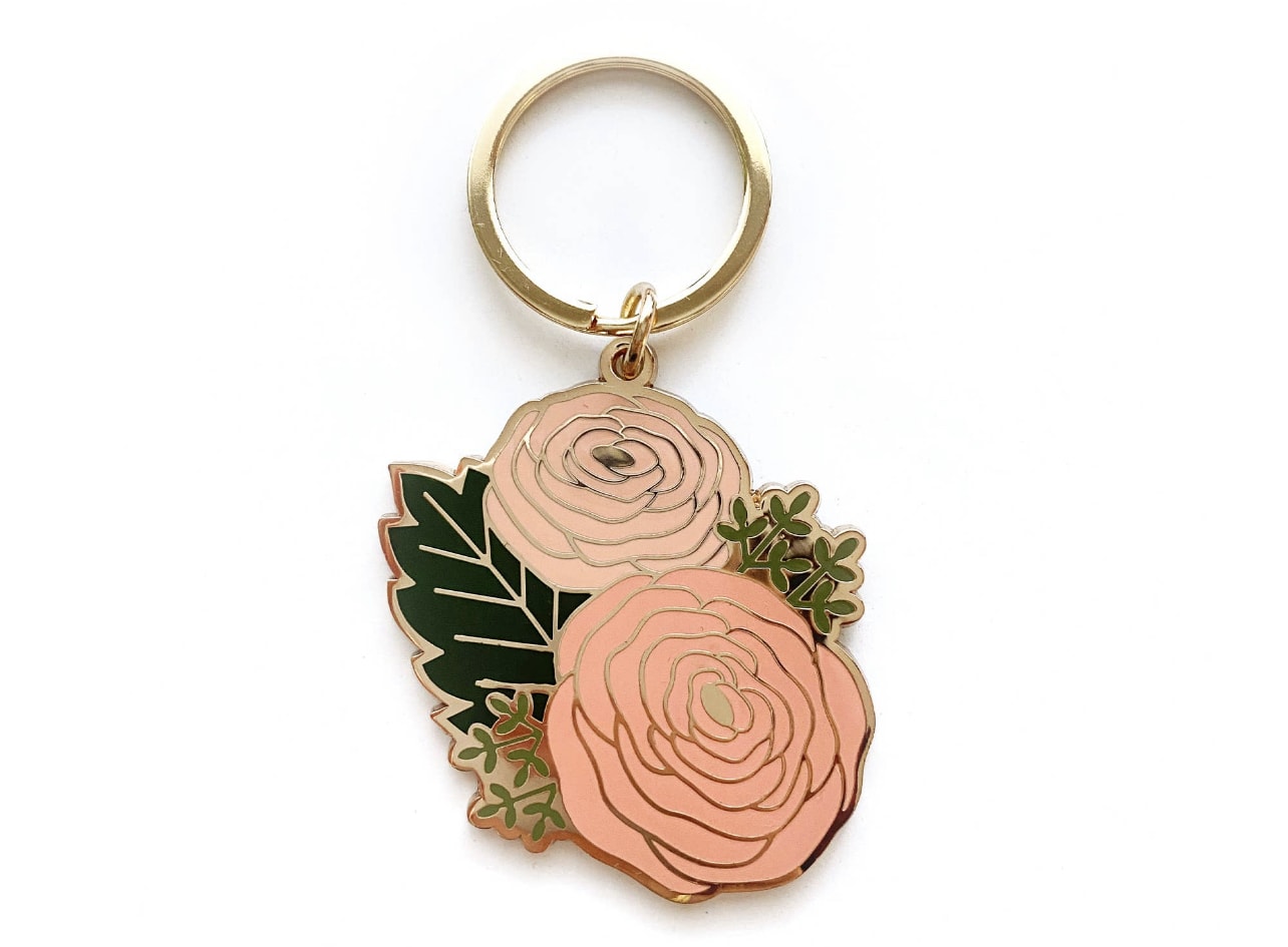 Floral keychain with two pink rose charms and green leaves