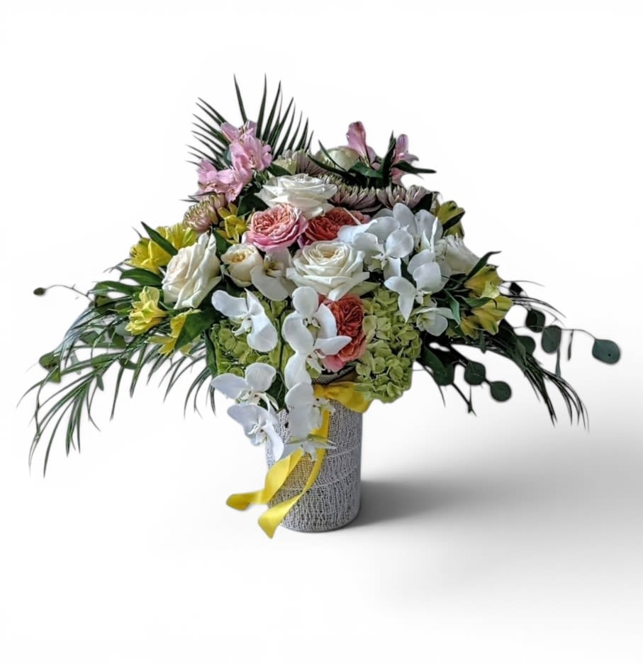 With Our Deepest Sympathy Bouquet Designer's Choice - Please call first for availability. Please allow 48 hours notice. Beautiful and filled with hydrangea orchids roses and more arranged in a tall modern glass cylinder vase wrapped in white jute ribbon. Perfect to send today to show them how much you care. Always made extra special and unique each time. Send them your deepest condolences.