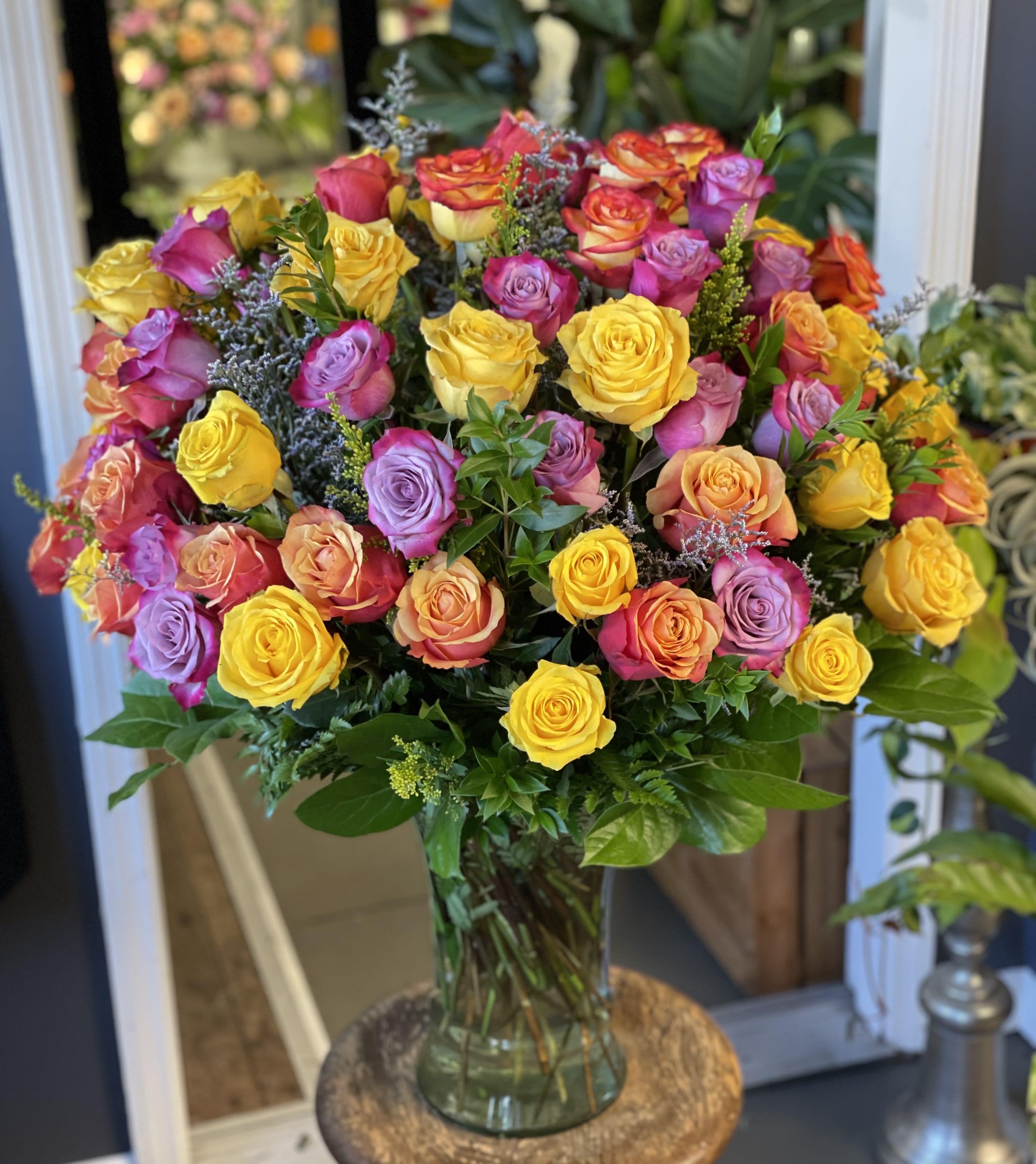 Bouquet of multicolored roses in a clear glass vase