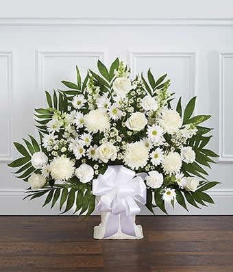 White Sympathy Floor Basket - A beautiful sympathy floor basket hand arranged with stunning white flowers. Created with fresh seasonal floral stems, including white roses, spider mums and snapdragons. Hand arranged by a local florist and delivered with care 