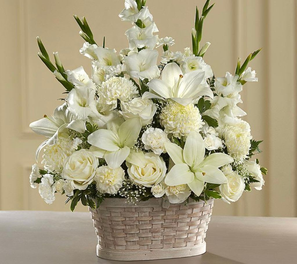 White floral arrangement in a woven basket
