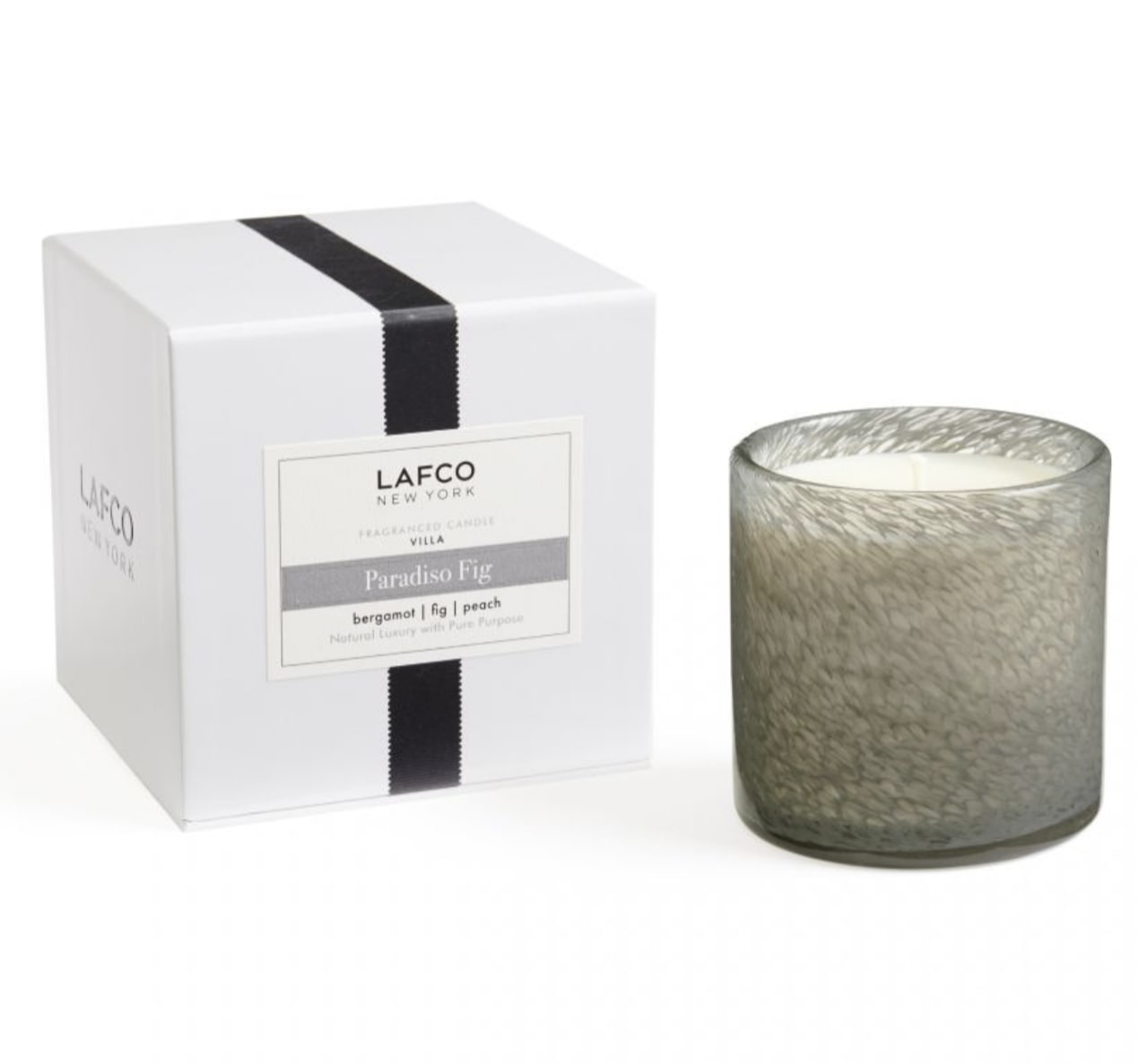 Fragranced candle in a glass holder beside its white gift box