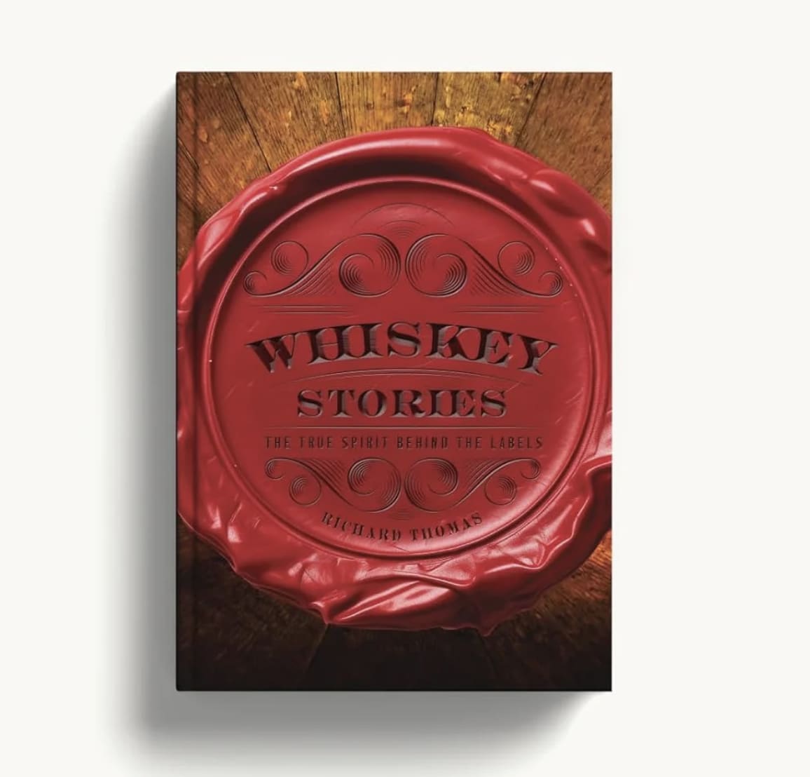 Red whiskey bottle cap on a wooden surface