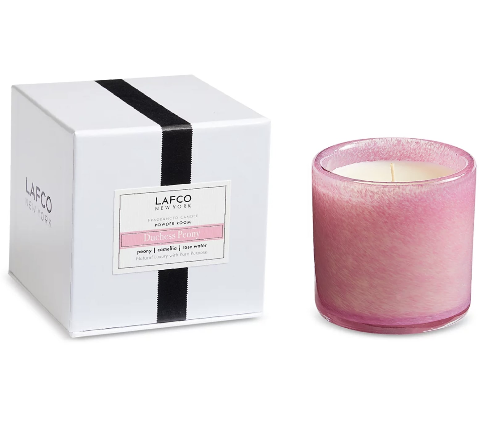 Pink scented candle in a glass holder beside its white box