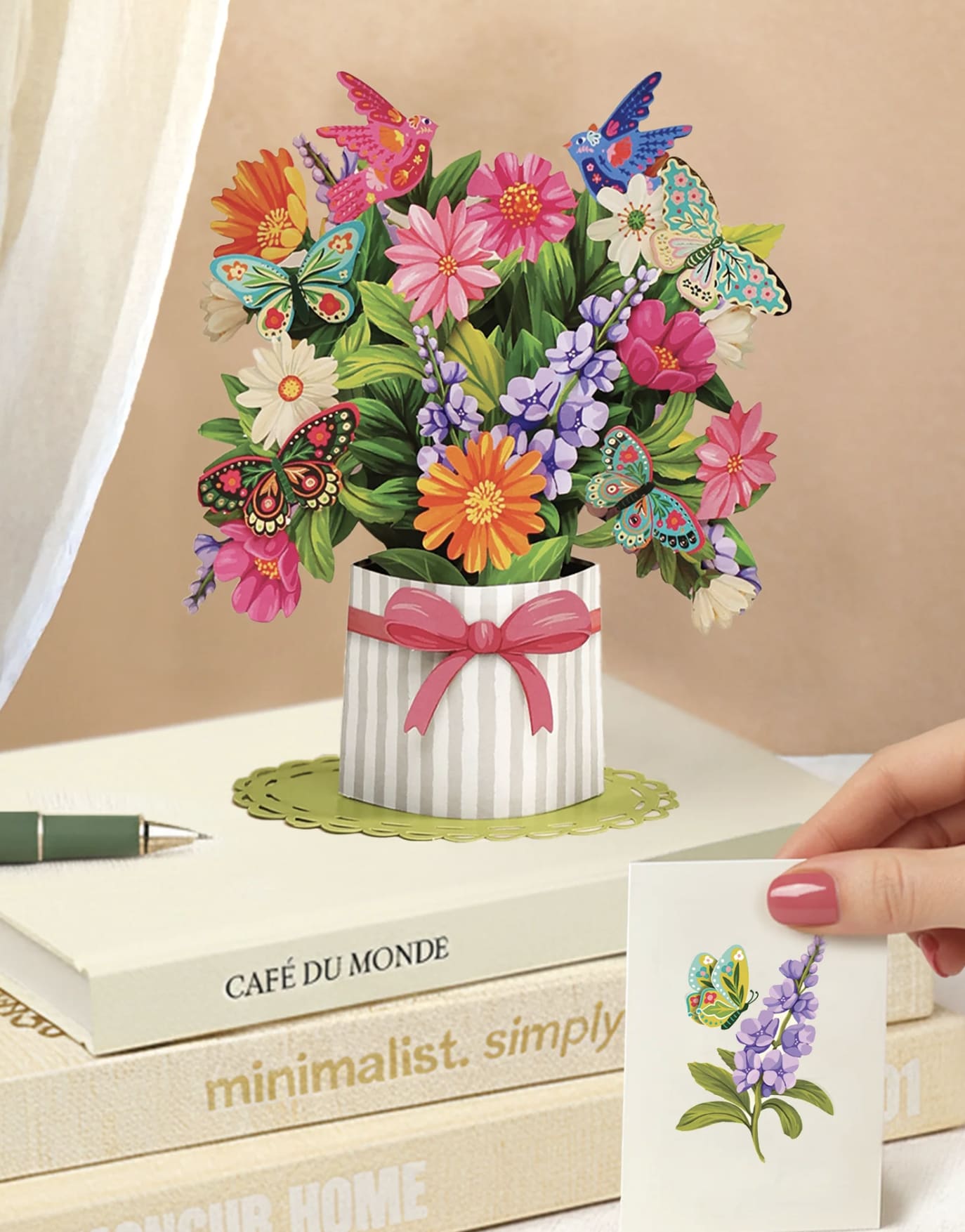 Pop-up bouquet card with colorful flowers and butterflies in a striped vase