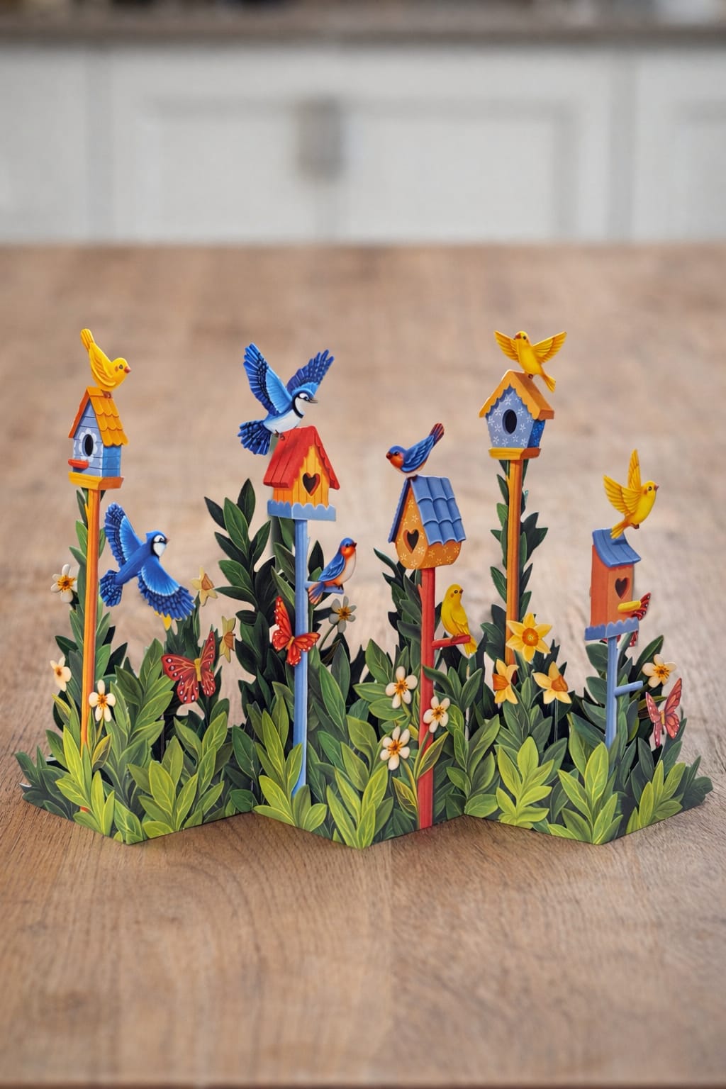 Decorative paper birdhouses with colorful birds and flowers