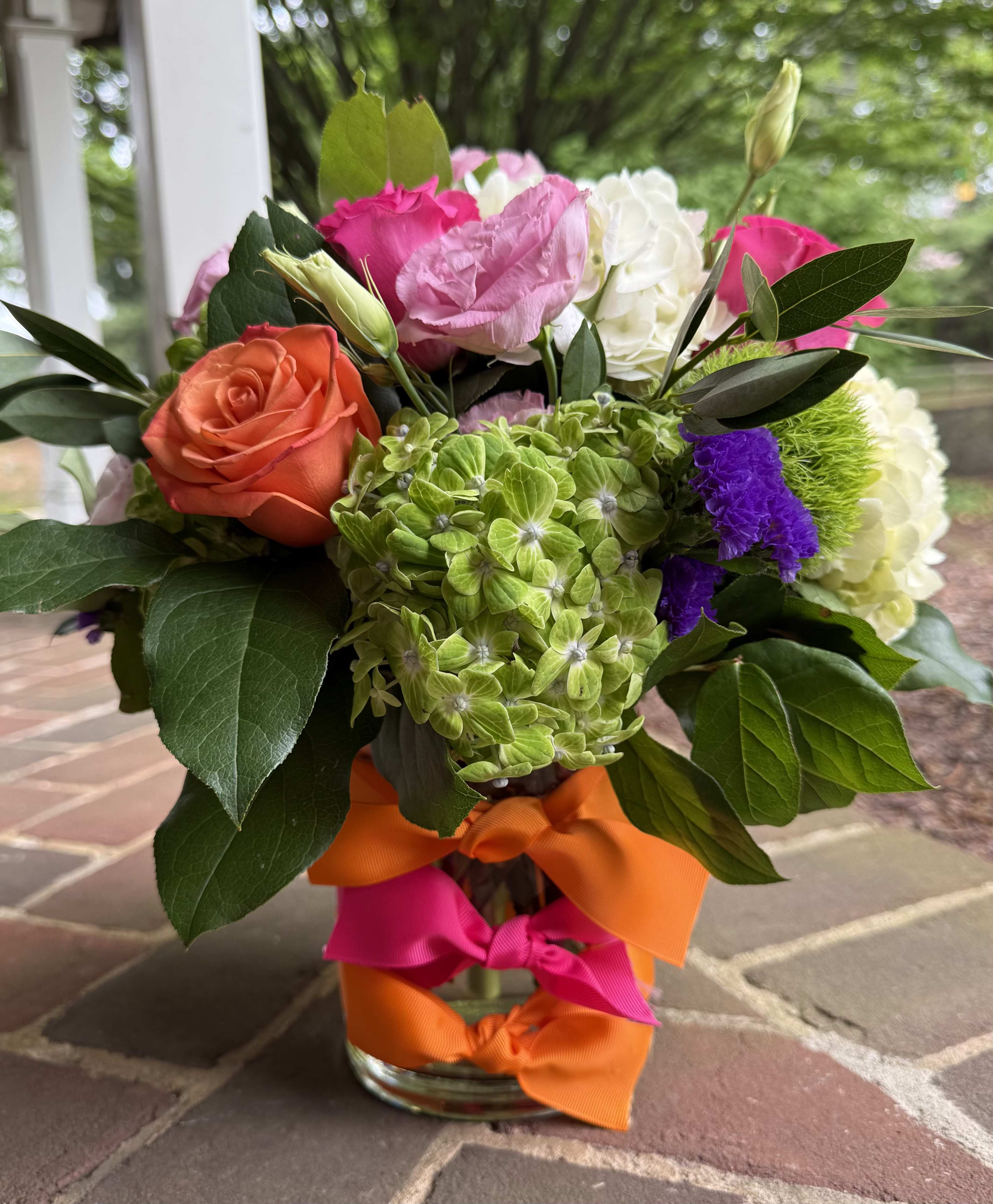 Summer Sunshine - Summer Sunshine - Wilmington DE, Local Delivery   Bursts of color and garden joy, Summer Sunshine is the arrangement that will show everyone for miles how much you love your mom. Orange and pink roses, pink lisianthus, green hydrangea, and purple statice combine to give a stunning visual, perfect for Mother's Day.  Perfect for birthdays, congratulations, get well wishes or just because, this cheerful bouquet adds a pop of color and a touch of luxury. Handcrafted by your trusted Wilmington florist, each arrangement is made fresh to order using premium seasonal flowers.  Why Choose Us? Hand-delivered by a Wilmington Florist Fast, reliable flower delivery in Wilmington, DE High-end blooms, expertly arranged with care.  Order now and brighten someone's day with Summer Sunshine - a standout floral gift from your go-to Wilmington, Delaware flower shop. 