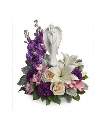 Purple and white floral arrangement with an angel figurine
