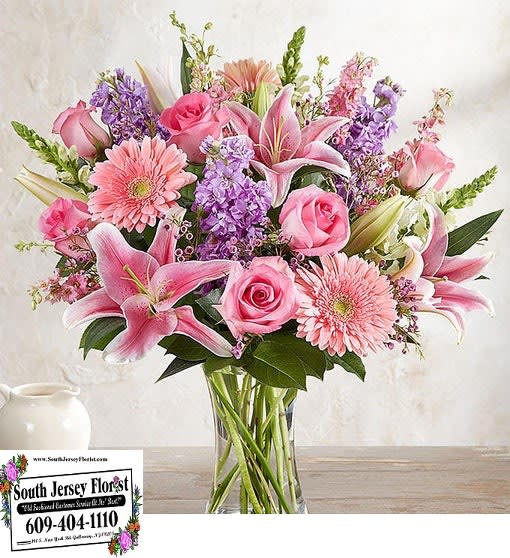 Pink and purple mixed bouquet in a clear glass vase