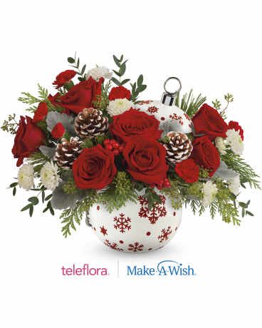 Red roses and white flowers in a snowflake-patterned vase