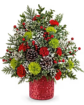 Holiday Cheer Tree -  Holiday Cheer Tree is brimming with joy! Red carnations, green mums, and winter accents are hand-arranged in red container while supplies last or we will sub container with a small wicker basket add red ribbon can sit very nice on a table or desk to brighten and enlighten the space.     Available in Standard Deluxe and Premium  size approximate 17 3/4" H x 13 1/2" W 