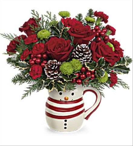 Red roses in a snowman mug with pinecones and holiday greenery