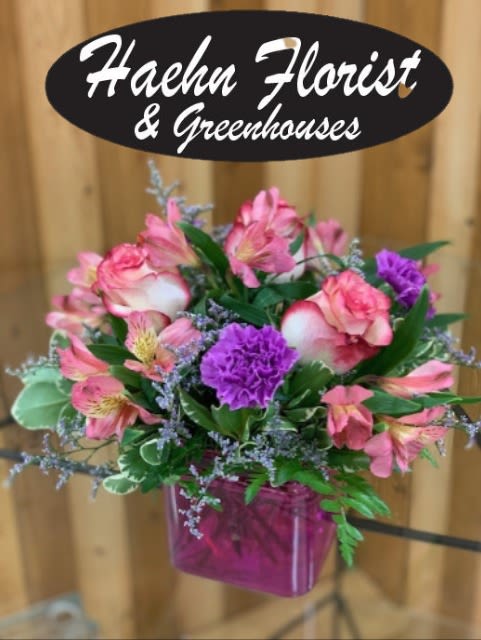 A little beauty - Short vase with roses, daisies and miniature carnations. Designed at Haehn Florist in Wapakoneta Bright &amp; Cheerful Everyday Arrangement  Add a burst of joy to any day with this simple yet elegant floral arrangement from Haehn Florist &amp; Greenhouses in Wapakoneta, Ohio. Featuring a beautiful mix of bright, bold colors, this design is perfect for celebrating life’s little moments, saying “thank you,” or simply bringing cheer to someone’s home or office.  Our talented florists carefully select fresh seasonal blooms to create an uplifting display that’s both timeless and vibrant. Whether you’re surprising a friend, sending love to family, or treating yourself, this everyday arrangement is the perfect choice to brighten any space.  Available for same-day flower delivery in Wapakoneta and surrounding areas, this cheerful bouquet is handcrafted with care right here at:  Haehn Florist &amp; Greenhouses 410 Hamilton Rd. Wapakoneta, OH 45895 Phone: 419-738-8485  Order online today and let Haehn Florist help you spread happiness with flowers!