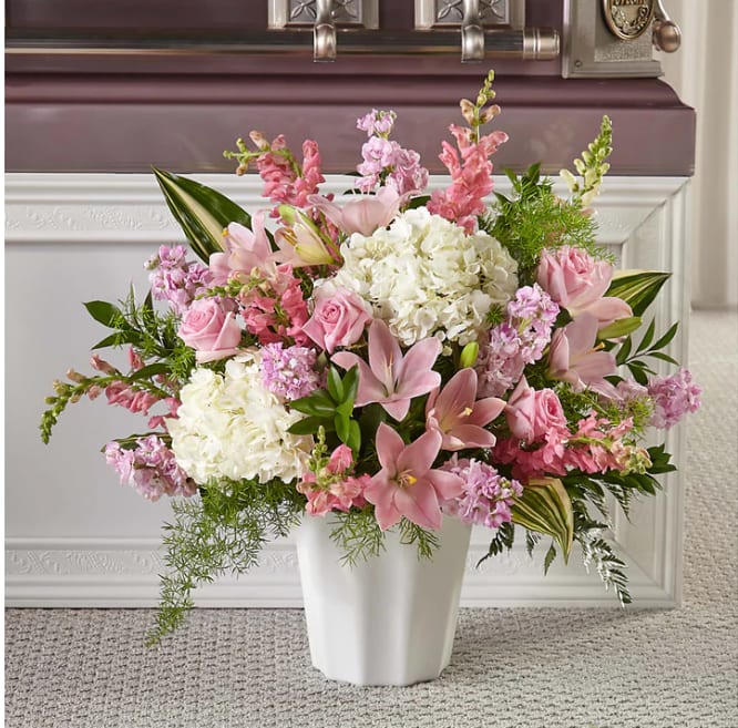 Pink and white floral arrangement in a white vase