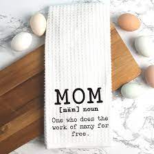 White towel with "MOM" text beside pastel eggs