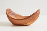 Curved wooden bowl on a plain light background