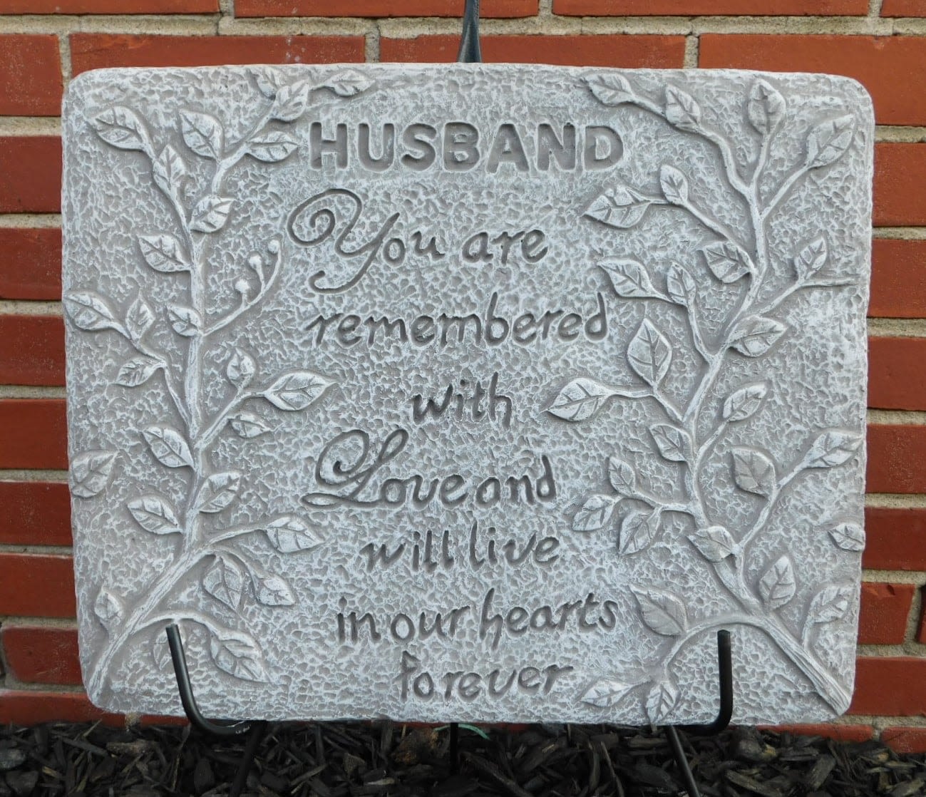 Decorative memorial plaque with the words "Husband, You are remembered with love and will live in our hearts forever."