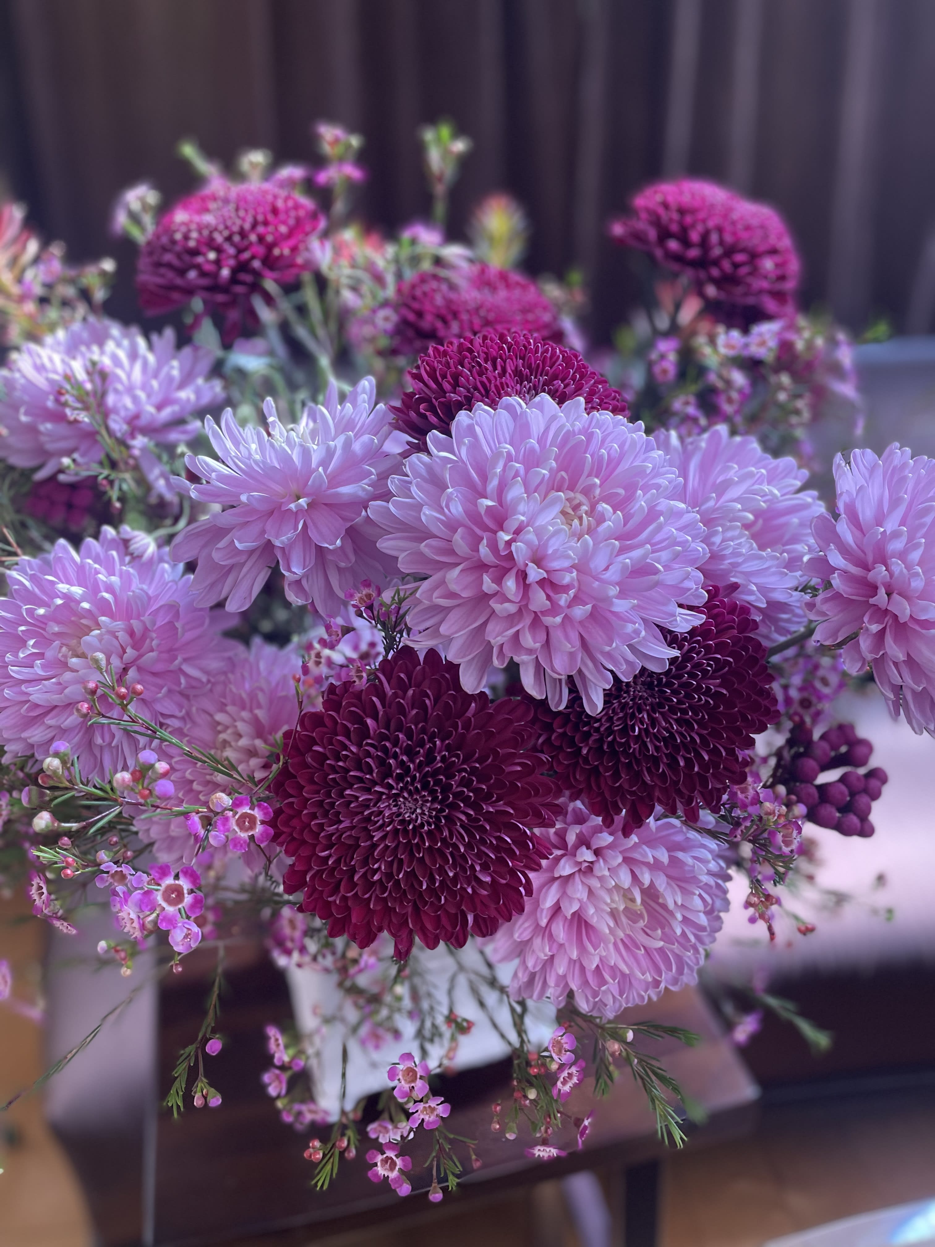 Bouquet of pink and magenta chrysanthemums with small pink filler flowers