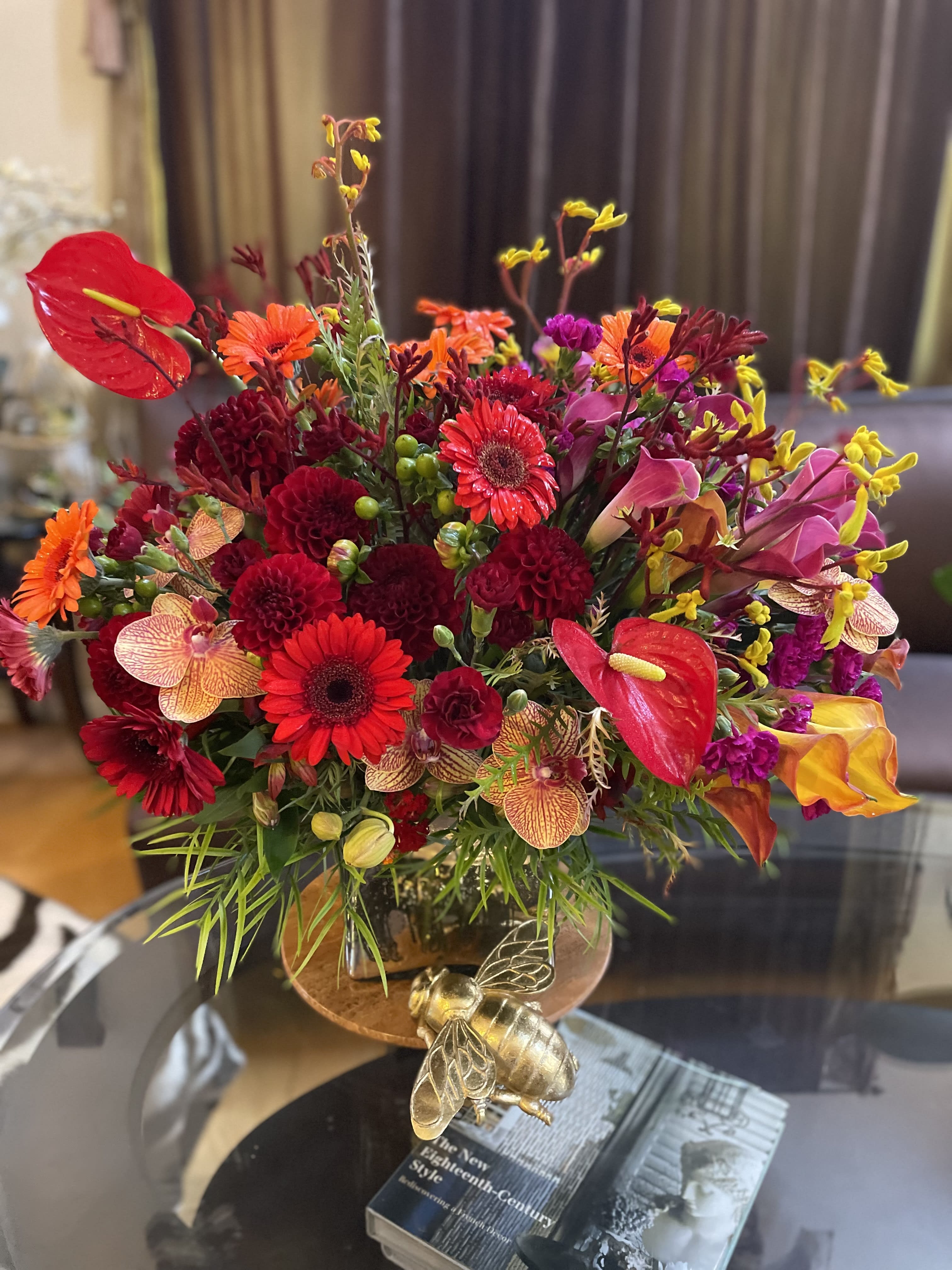 Bright mixed bouquet with red, orange, pink, and yellow flowers in a vase