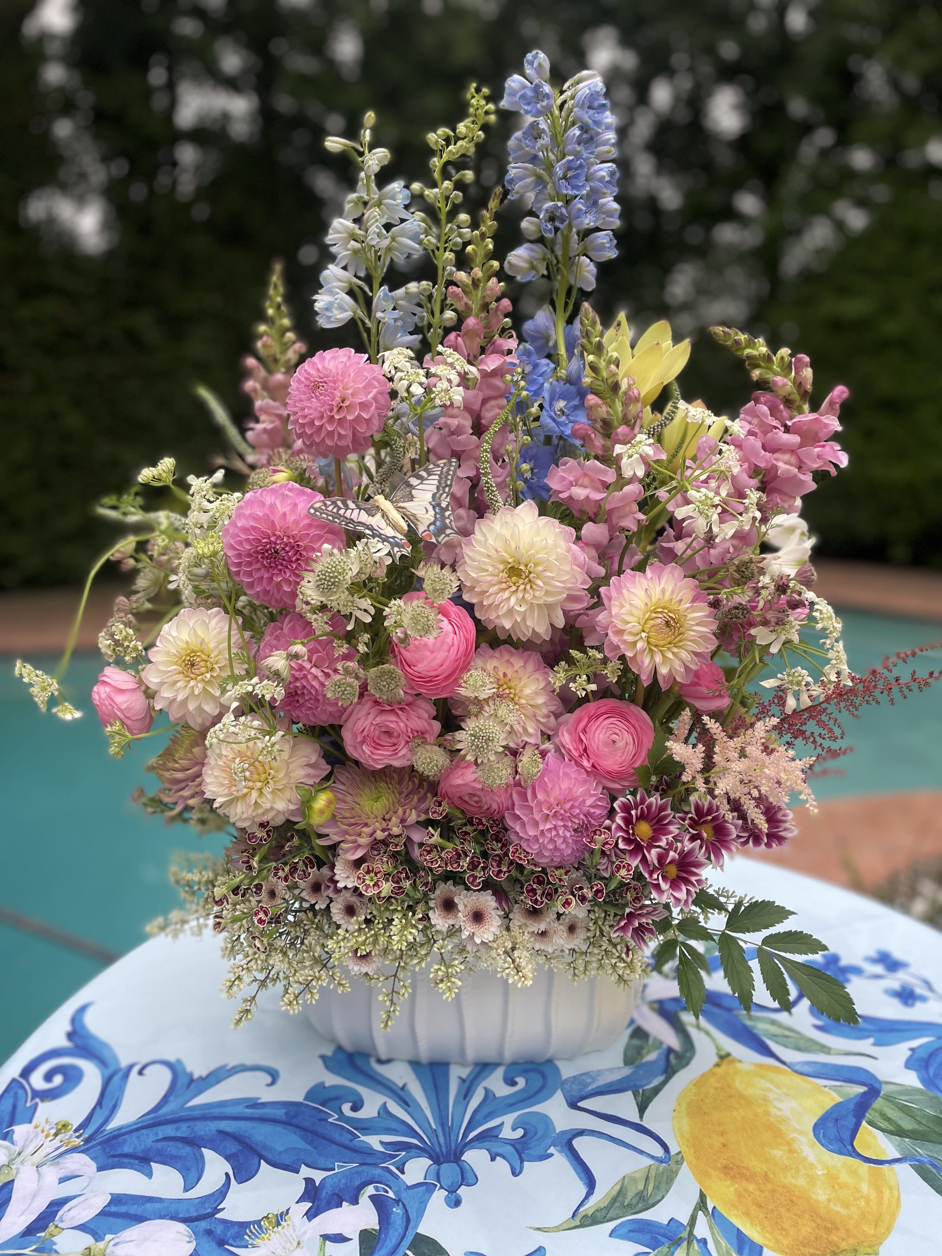 Mixed pastel flower arrangement in a white bowl vase