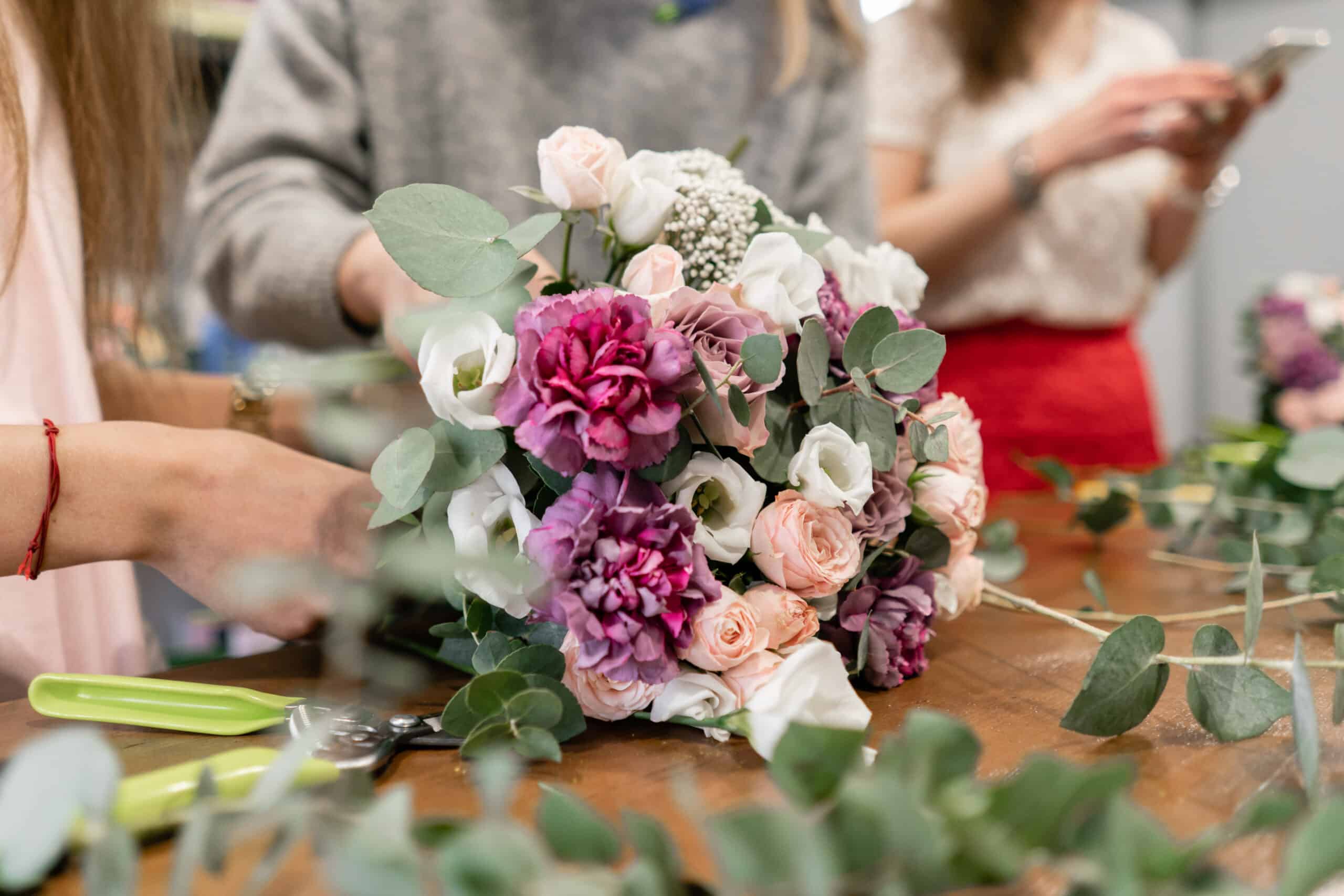 Hand-tied bouquet of pink, white, and purple flowers with eucalyptus