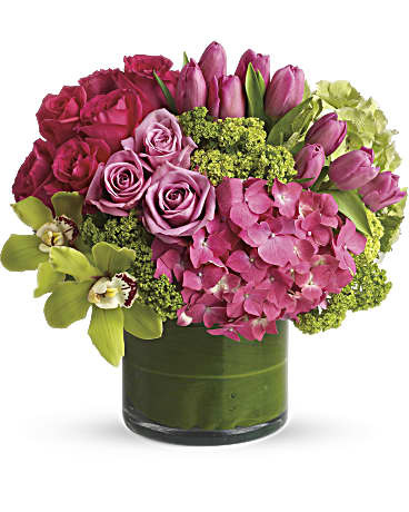 Pink roses, tulips, and hydrangea in a green glass vase