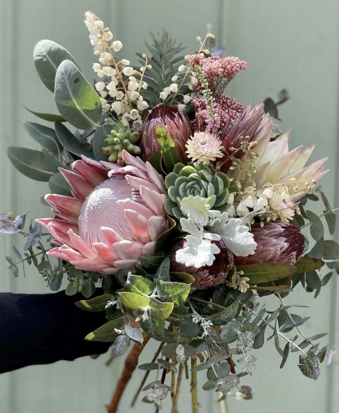 Hand-tied bouquet with pink protea and succulents