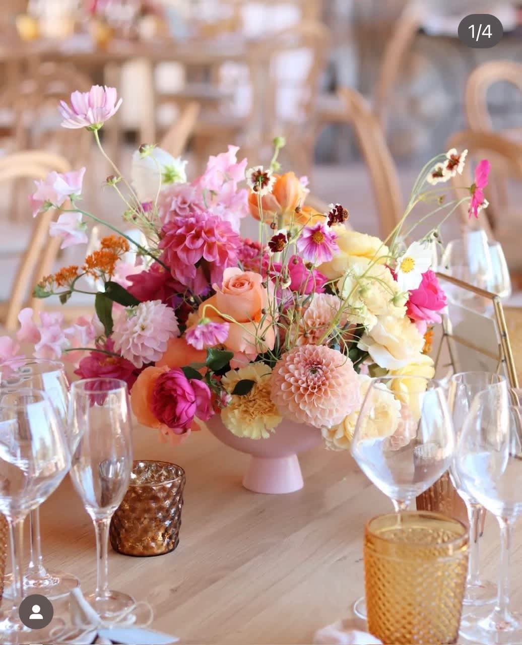 Pastel floral centerpiece in a pink vase on a table