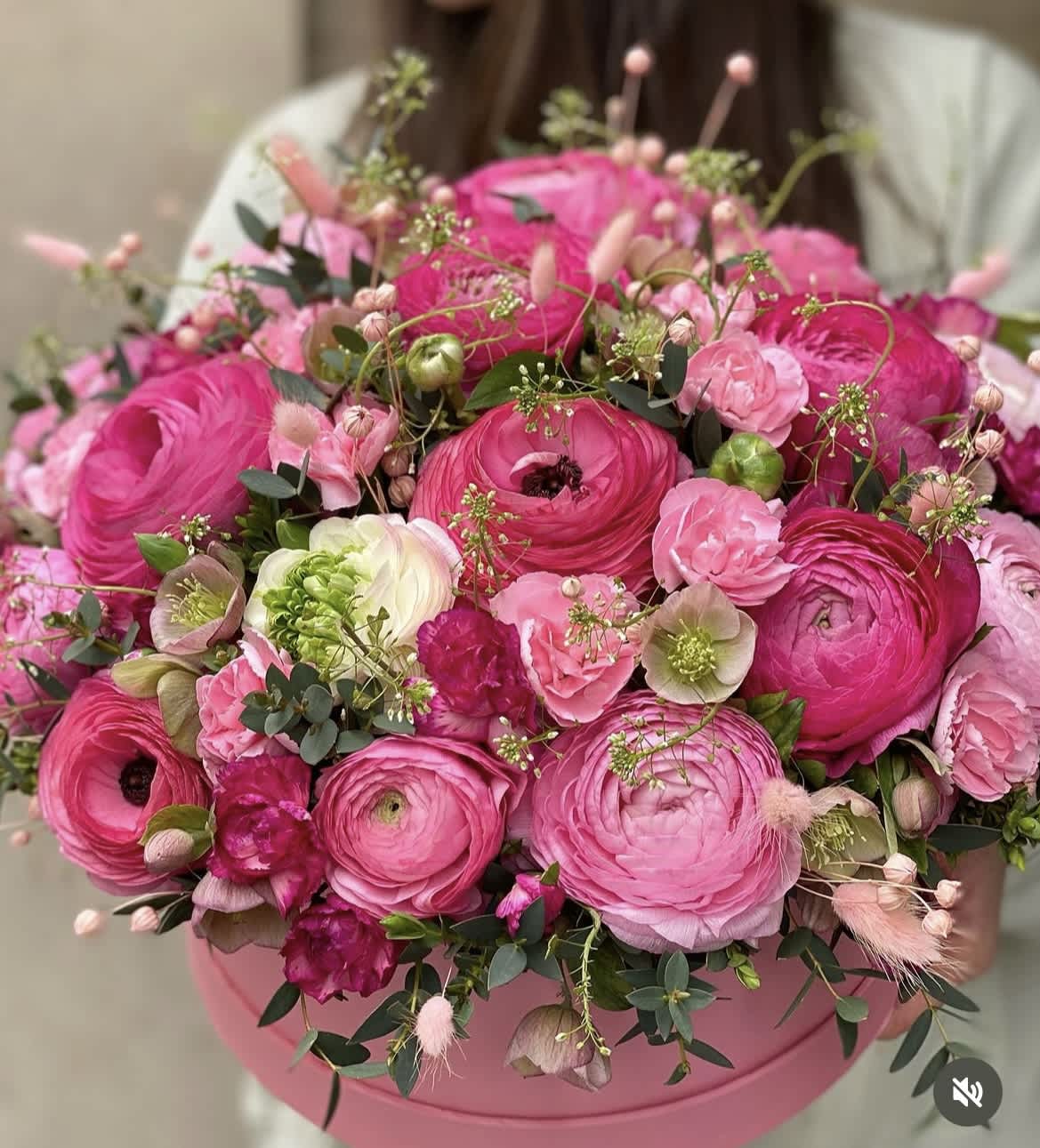 Pink ranunculus bouquet in a round pink box