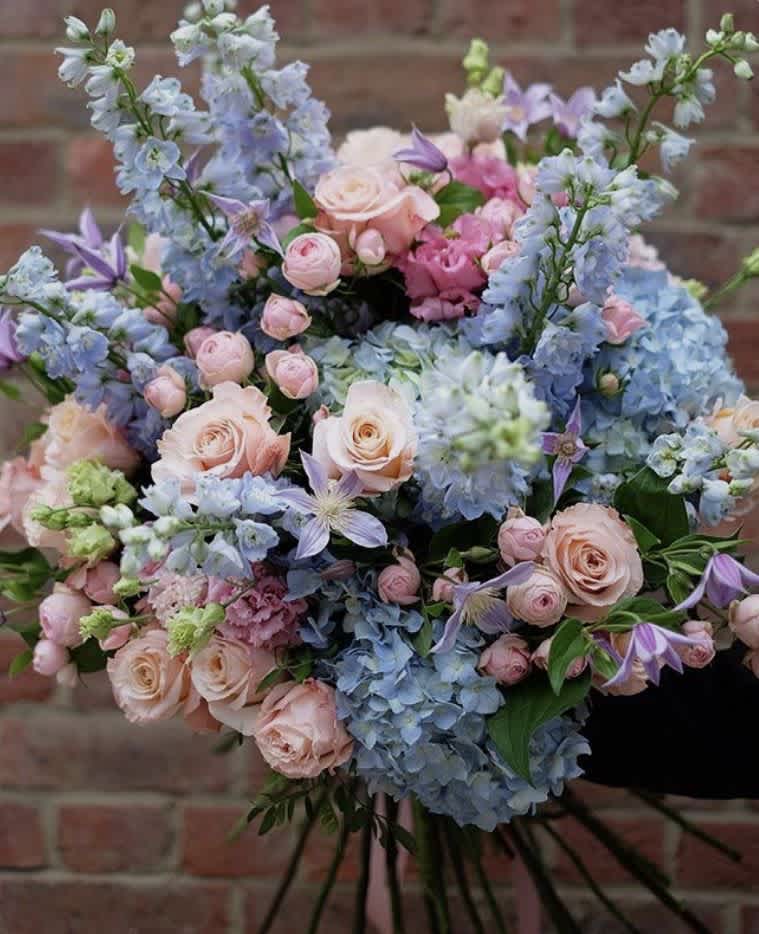 Pastel bouquet of roses, hydrangeas, and lavender flowers