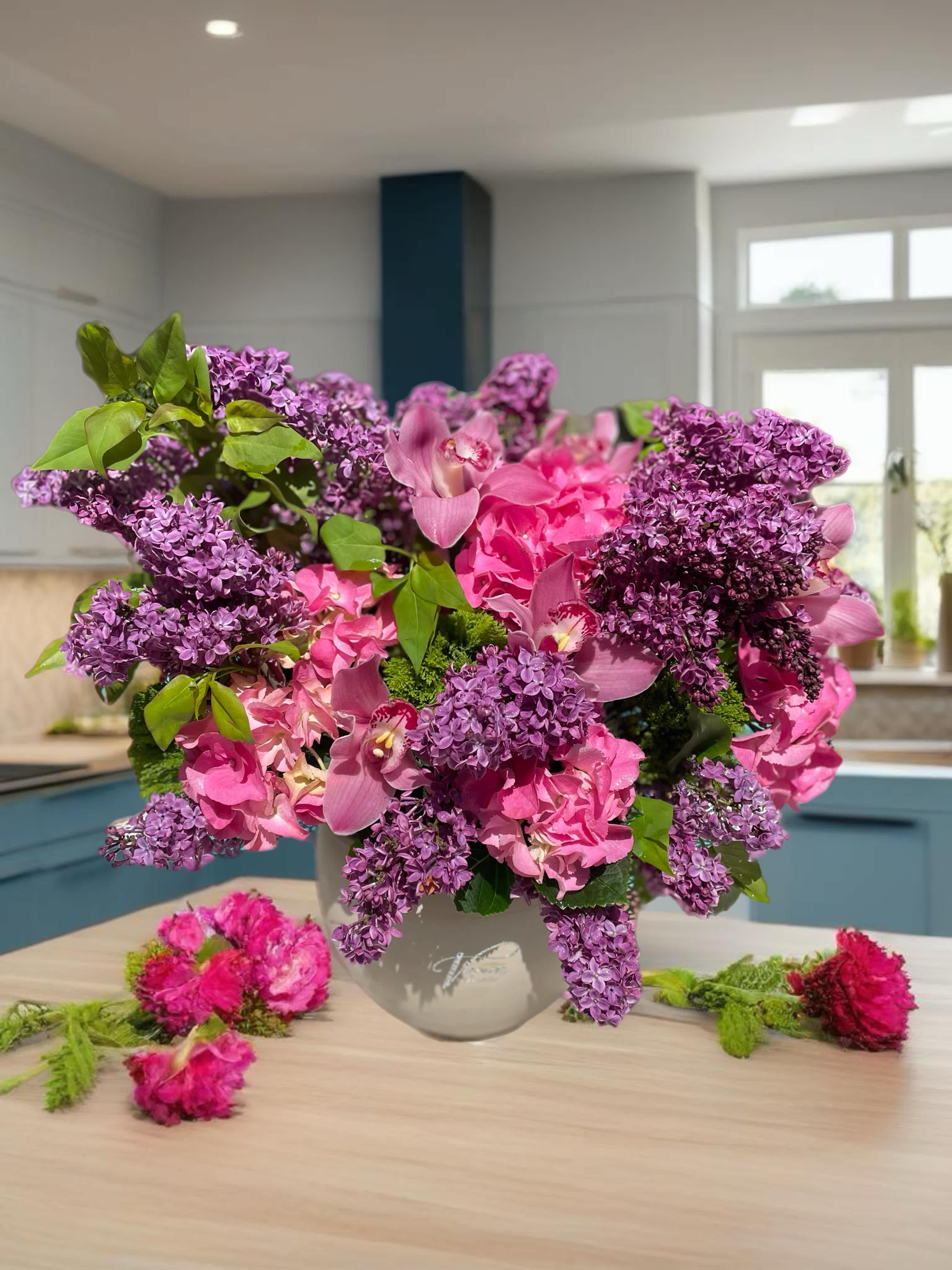 Pink and purple floral arrangement in a gray vase